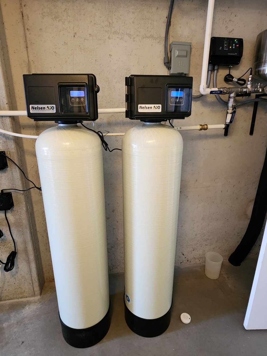 Dual Fleck 2510AIO iron filter tanks installed for high iron well water
